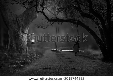 A rural black-and-white picture with no electricity, only a lantern that illuminates a girl on a slow horse in the lonely night.