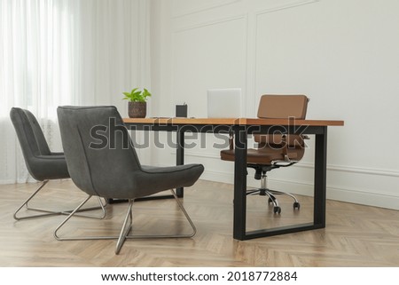Director's office with large wooden table and comfortable armchairs. Interior design Royalty-Free Stock Photo #2018772884