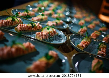 appetizer with salmon pate with lime on a blue plate close-up with bokeh