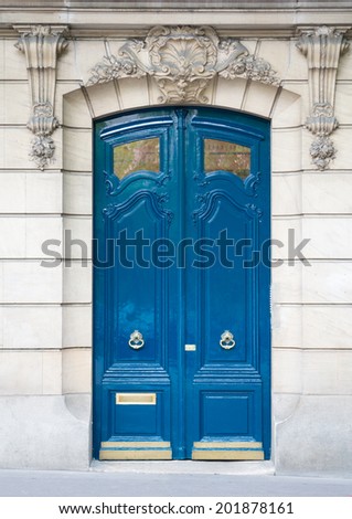 Blue old wooden door in Paris, France