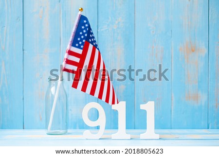 911 text and United States of America flag on wooden table background. Patriot Day, September, memorial and Never Forget concept