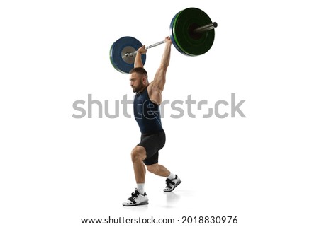 Full length portrait of man in sportswear exercising with a weight isolated on white background. Fit young muscular caucasian model with barbell training at abstract gym. Sport, weightlifting concept Royalty-Free Stock Photo #2018830976