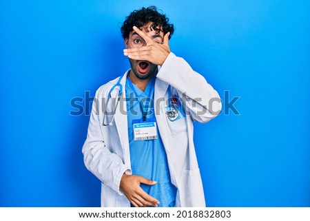 Young hispanic man wearing doctor uniform and stethoscope thinking looking tired and bored with depression problems with crossed arms. 