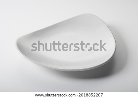 From above semicircle shaped empty bowl with white enamel placed on gray table