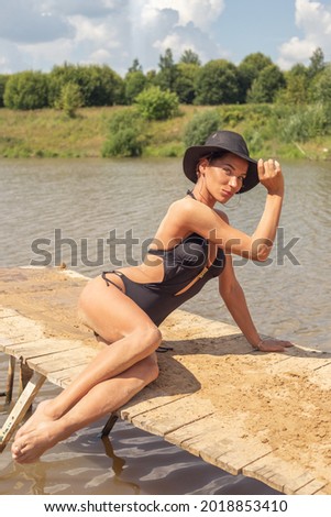 Young girl in a bikini sunbathing on the beach in summer