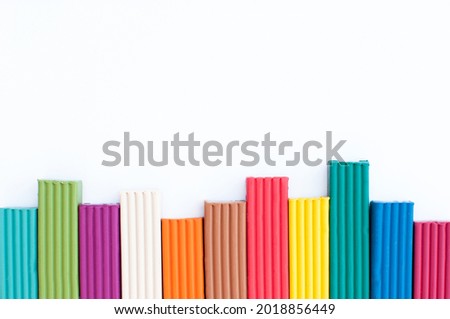 Plasticine columns of different colors on a white background with a place for text Royalty-Free Stock Photo #2018856449
