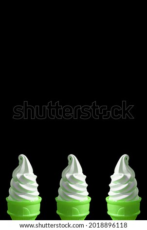 Three of Bright Green Lime Soft Serve Ice Cream Cones on Black Background