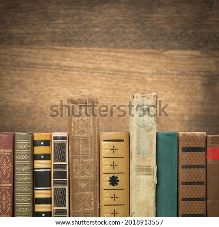 A collection of antique retro old books on a shelf
