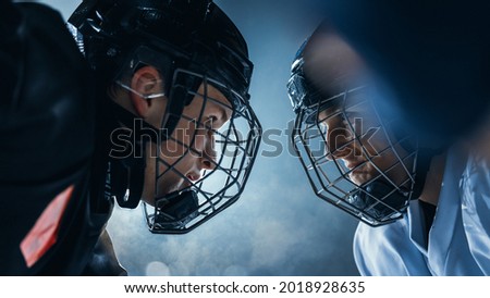 Ice Hockey Rink Arena Game Start: Two Professional Players Aggressive Face off, Sticks Ready. Intense Competitive Game Wide of Brutal Energy, Speed, Power, Professionalism, Skill. Close-up Shot. Royalty-Free Stock Photo #2018928635