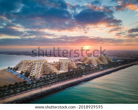 Sunrise over Marjan Island seafront reclaimed land artificial island in emirate of Ras al Khaimah in the United Arab Emirates aerial view Royalty-Free Stock Photo #2018929595