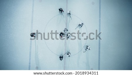 Top View Ice Hockey Rink Arena Game Start: Two Players Face off, Sticks Ready, Referee Ready to Drop the Puck. Intense Game Wide of Competition. Aerial Shot Royalty-Free Stock Photo #2018934311