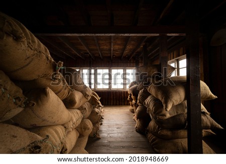 Old warehouse with jute bags.
The jute bags cotain fresh tea leaves. Royalty-Free Stock Photo #2018948669