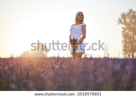 Girl in lavender field at sunset