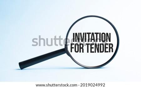 Magnifying glass with the word INVITATION FOR TENDER. Business concept