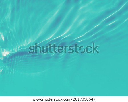 Reflection​ on​ surface​ blue​ water​ in​ the​ ocean. Abstract​ of​ surface​ blue​ water​ for​ background. Closeup​ abstract​ of​ surface​ blue​ water. Splash​ed​ water​ in the​ swimming​pool.