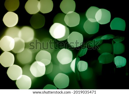 Abstract light bulb with green bokeh pattern background.