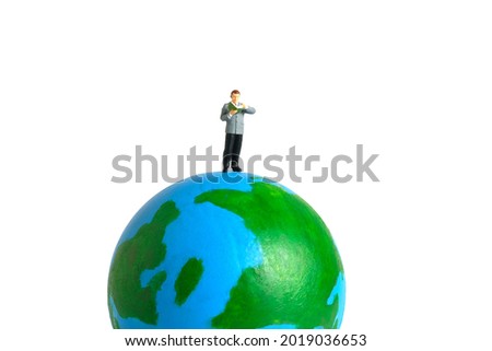 Miniature people toy figure photography. International or National reading day. A men student standing above earth globe while read a book, isolated on white background. Image photo