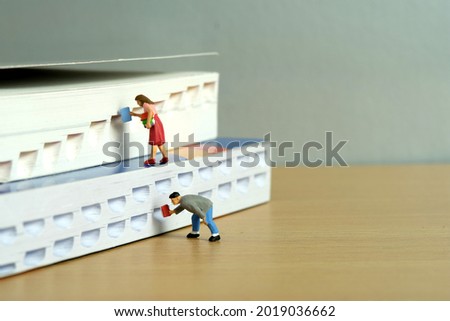Miniature people toy figure photography. Bookshelf library concept. A group of student pupil returning and borrow a book. Image photo Royalty-Free Stock Photo #2019036662
