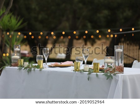 View of the bride and groom's table at a wedding reception.