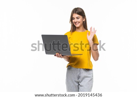 Happy young woman chatting on conference video call looking at laptop on white background