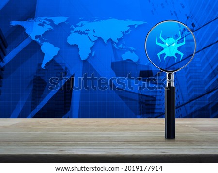 Virus computer icon with magnifying glass on wooden table over world map, modern city tower and skyscraper, Technology internet security concept, Elements of this image furnished by NASA