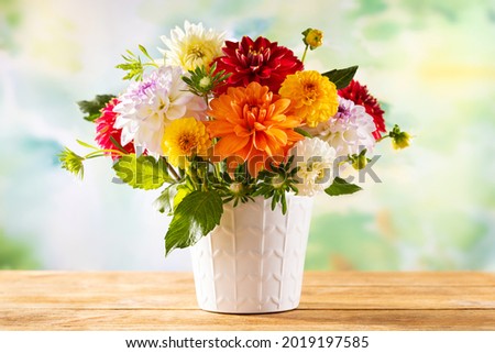 Autumn still life with garden flowers. Beautiful autumnal bouquet in vase on wooden table. Colorful dahlia and chrysanthemum. Royalty-Free Stock Photo #2019197585