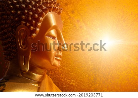 Buddha face head looking at wisdom light calm peace to nirvana way of life in Asian religion concept.