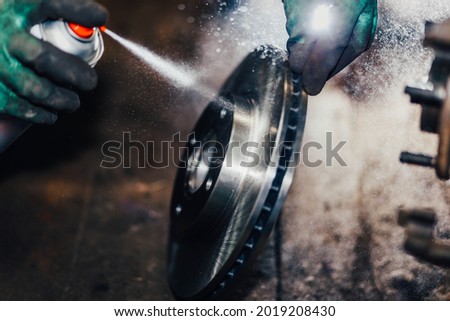 car brake disc treatment with spray, brake cleaner. Royalty-Free Stock Photo #2019208430