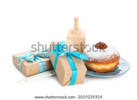 Gift boxes with dreidel and donut for Hanukkah on white background
