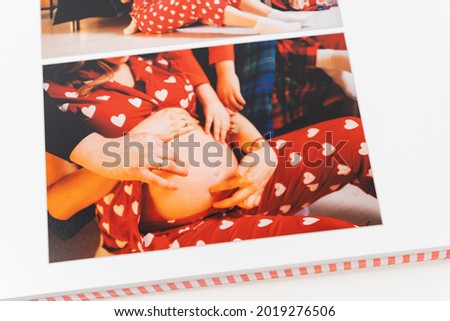 pages of a photobook from a new year's family photo shoot. printed products. Store photos in an album. services of photographer and designer. happy pregnancy and anticipation of the birth of a baby