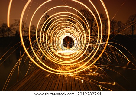 Light Painting, Steel wool photography, Light Spinning with reflections in the water. 