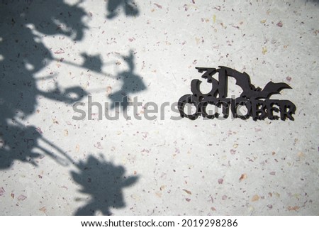 On the table are shadows from plants,  Halloween, Autumn. Inscription in black October 31.