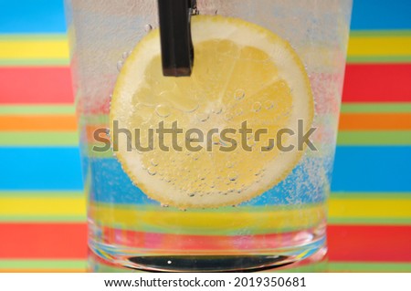 Picture of Fresh lemon inside glass with lemonade drink with  colorful background