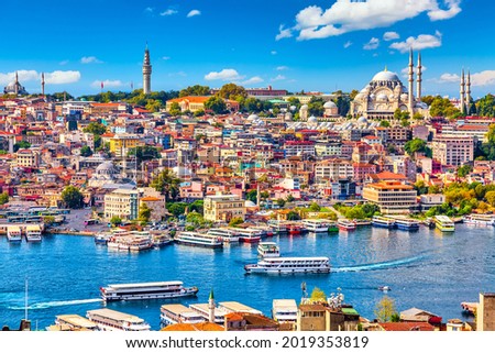 Touristic sightseeing ships in Golden Horn bay of Istanbul and mosque with Sultanahmet district against blue sky and clouds. Istanbul, Turkey during sunny summer day Royalty-Free Stock Photo #2019353819