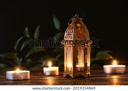 Muslim lamp and candles on dark background Royalty-Free Stock Photo #2019354869