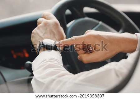 Young man with modern smart watch driving car Royalty-Free Stock Photo #2019358307