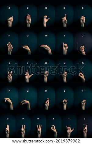 Dramatic colour image of male hands demonstrating all ASL American sign language alphabet letters A-Z with empty copy space for editors