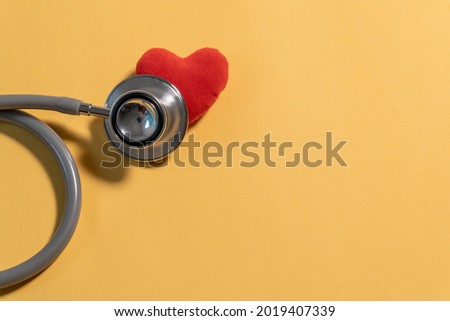 Single Head Stethoscope with red heart  on yellow background