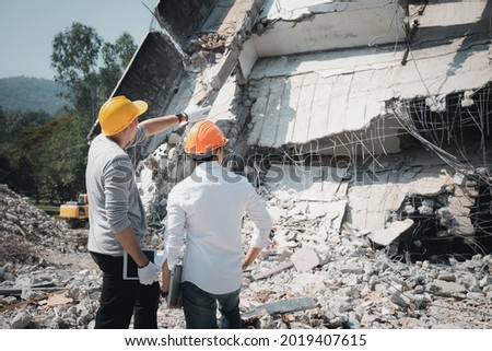 Demolition control supervisor and contractor discussing on demolish building. Royalty-Free Stock Photo #2019407615