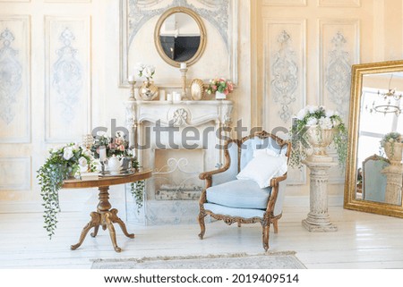 luxury rich sitting room interior in
beige pastel color with antique expensive furniture in baroque style. walls decorated with stucco and frescoes