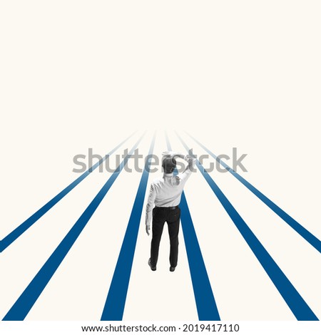 Successful businessman standing on blue lines, way or path to success and goal. Right direction. Concept of finance, economy, professional occupation, business and career.