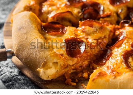 Homemade Pepperoni Stuffed Crust Pizza with Cheese Royalty-Free Stock Photo #2019422846