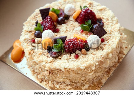 Birthday cake. Garnished with fruits, berries and chocolate. Festive mood. High quality photo