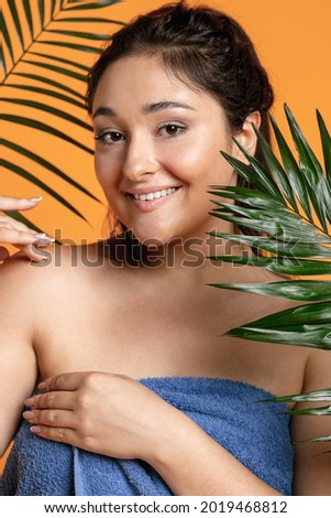 Pretty caucasian female model dreaming at studio. Happy smiling positive plus size woman. Concept of beauty, body, skin care, healthy lifestyle, human emotions, wellbeing , spa.
