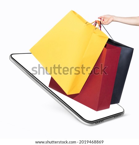 Online shopping. Boutique paper bags placed on the phone screen over white background. Concept of online trades, sales, teleworking. Copyspace for ad, offer