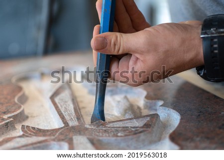 caucasian man hands bushhammered a tombstone in a workshop, work concept Royalty-Free Stock Photo #2019563018