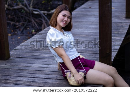 Portrait of Asia woman on a wooden bridge in the mangrove forest