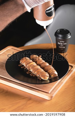 mini pancakes with different types of chocolate in black plate  Royalty-Free Stock Photo #2019597908