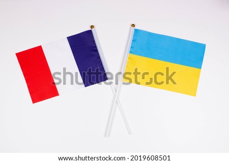 Flag of France and flag of * crossed with each other on a white background. Isolated. The image illustrates the relationship between countries. Photo for news and articles on the media