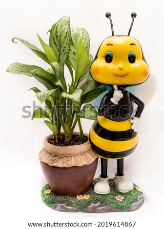 an image of a plant and a Bee decoration 